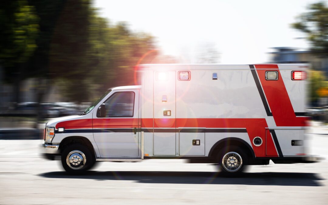This is a photo of an ambulance speeding to the scene of an emergency, demonstrating the importance of property ambulance maintenance.